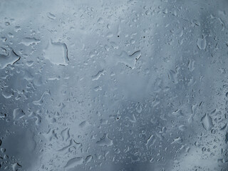 Raindrops on the window, rainy day. Storm clouds