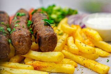 Chargrilled Greek / Arabic Lamb / Pork Skewers Served with Fries / Chips Salad Tzatziki Sauce Tomatoes Onions Lettuce
