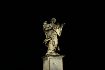 Angel's bridge in Rome. Marble statue of the Angel. Night, black background