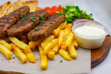 Chargrilled Greek / Arabic Lamb / Pork Skewers Served with Fries / Chips Salad Tzatziki Sauce Tomatoes Onions Lettuce