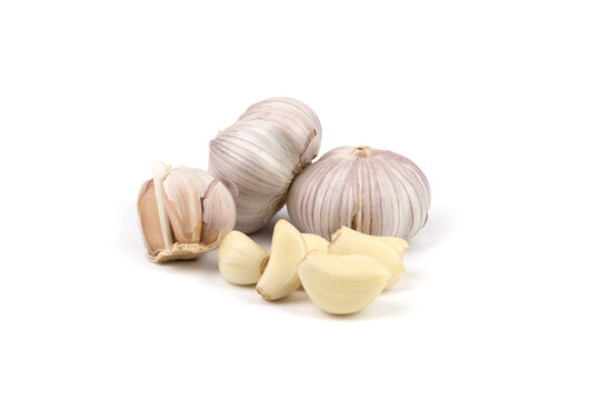 fresh garlic in heads and divided into teeth on a white isolated background