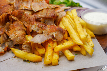 Greek / Arabic Lamb / Pork Meat with Fries / Chips Tzatziki Salad Tomatoes Onions Lettuce