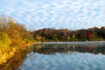 autumn trees reflected in water