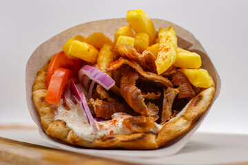 Lamb / Pork Gyros With Chips Bread Wrap Salad Tomatoes Seasoning Fries Wrapped Up Presented Wooden Greek Food Fast 
