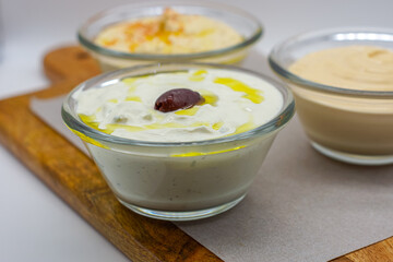 Authentic Tzatziki, Feta Sauce and Hummus Dips In Glass Bowls