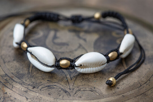 White shell macrame boho bracelet on metal background