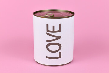 Love concept with large can and label saying 'LOVE' on pink background