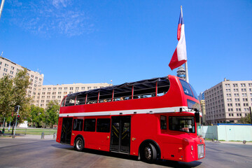 Fototapeta na wymiar red double-decker bus. chile flag in the background