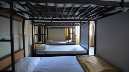 Empty room for a cheap hostel with bunk beds.