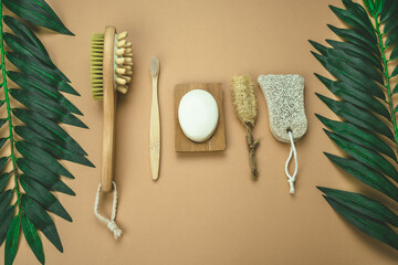 Fototapeta na wymiar flat lay eco friendly spa kit, massage brush, bamboo toothbrush, pumice, wooden comb, natural soap, loofah sponge