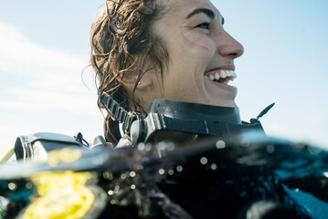 Woman Smiling while Scuba Diving with joyful toothy grin during tropical underwater adventure with...