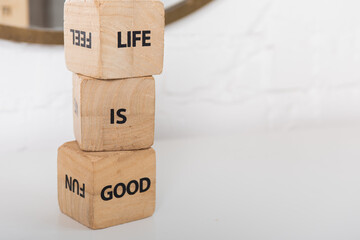 inscription on wooden cubes that life is wonderful on a light background
