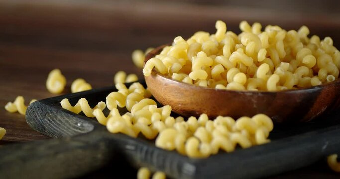 Pasta dry cavatappi on the cutting Board rotates slowly.