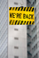 Office building with reopening message sign after the corona lockdown