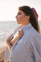 Young beautiful woman posing on summer beach.