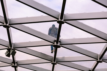 glass roof of a building with man walking on it