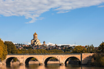 Saarbrucken Bridge with Sameba Cathedral in the background, in Tbilisi, Georgia - obrazy, fototapety, plakaty