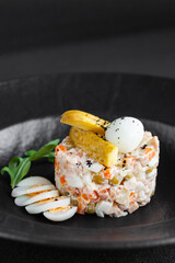 Traditional salad olivie with mayonnaise made from chopped boiled vegetables, eggs, meat