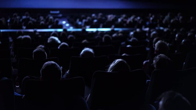 Social event - Large crowd of people in a movie theater - cinema
