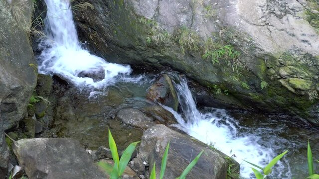 Close footage of waterfall passing through rocks. Footage shot at Jhalong, Dooars, West Bengal - India.
