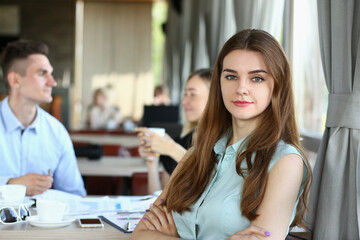 young beautiful woman have meeting with her subordinates in cafe