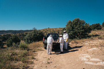 Beekeepers preparing material to go collect honey from the honeycombs 