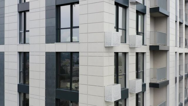 Aerial view of a newly built modern apartment building facade. Elevator shot