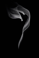 Abstract white smoke or steam swirls on black background