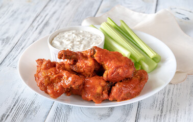 Bowl of buffalo wings with blue cheese dip