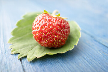 Image of red tasty strawberry on wooden background. Side view. Closeup