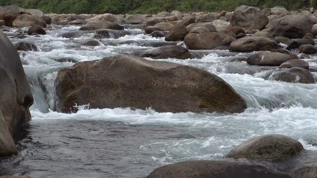 Water flowing on river bed of Joldhaka river, river stcok footage shot at Jhalong, a place of Dooars , north of West Bengal, India.