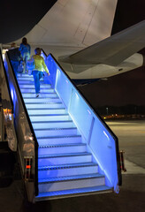 Night boarding on the plane on the ramp