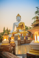 Fototapeta premium Beautiful big buddha image at Wat Phra That Doi Kham. Chiang Mai, Thailand. Wat Phra That Doi Kham (Wat Doi Kham or the Golden temple) is located at the top of a hill to the south west of the city.
