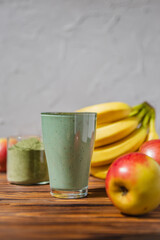 promotional shooting of a fruit cocktail for a healthy eating establishment. In the photo, a glass with a green drink made from fruits and algae spirulina powder