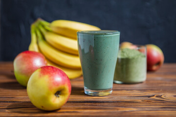 Smoothie with fresh red apple, banana and spirulina powder. Summer vitamin refreshing drink. Healthy detox diet