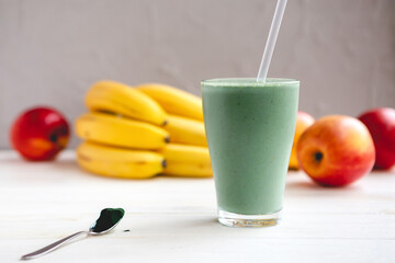 Smoothie with fresh red apple, banana and spirulina powder. Summer vitamin refreshing drink. Healthy detox diet