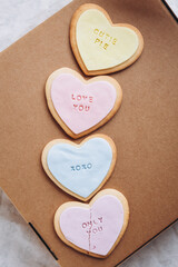 Valentine's Day presents: Heart-shaped cookies with colorful glaze and themed lettering for all lovers