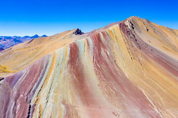 Aerial landscape of Rainbow Mountain. Apu Ausangate is behind. Mountain full of colors. Cusco Region, Peru