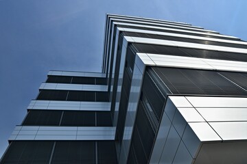Upward view of a business building. Corner of glazed office buildings.