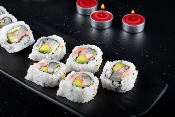 Raw fish sushi, shrimp, onion, avocado, lettuce and tiger's milk. rolls closeup