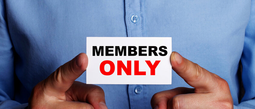 MEMBERS ONLY is written on a white business card held by a man.