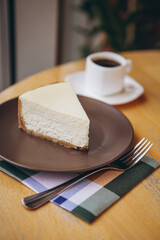 Piece of cake with coffee for breakfast on the table in a coffee shop