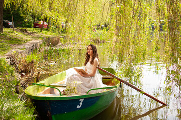 Portrait of young bride in stylish wedding dress on lake