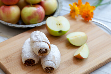 Apple pie rolls on wooden background