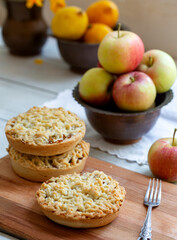Pieces of delicious apple pie on wooden background