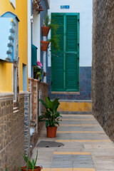 Fototapeta na wymiar Colorful buildings on a narrow street in spanish town Punto Brava, Tenerife, Canary islands, Spain.