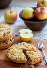 Pieces of delicious apple pie on wooden background
