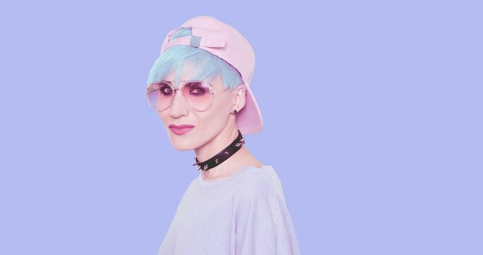 Fashion Sexy swag Girl with blue hair, stylish casual look  posing in studio against blue background. Urban stylish and accessories concept