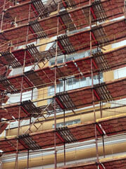 facade of a high-rise building, covered with scaffolding for renovation