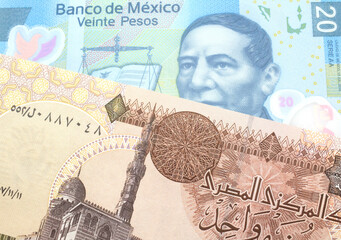 A one Egyptian pound bill with A blue Mexican peso note from Mexico close up in macro